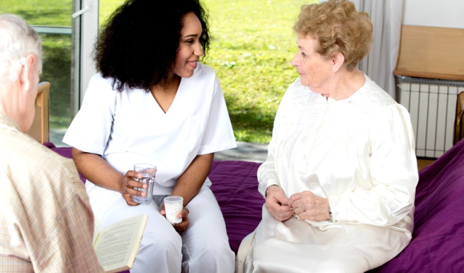 Nurse providing senior patient with medication in Bossier City, LA