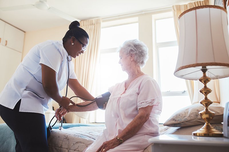 A Nurse checks an elderly Woman's blood pressure at a residential home in Bossier City, LA.