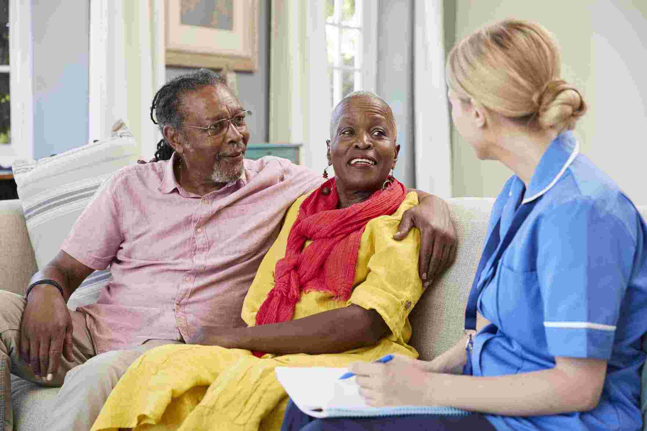 A nurse speaks with an elderly couple, highlighting a care facility in Bossier City, LA