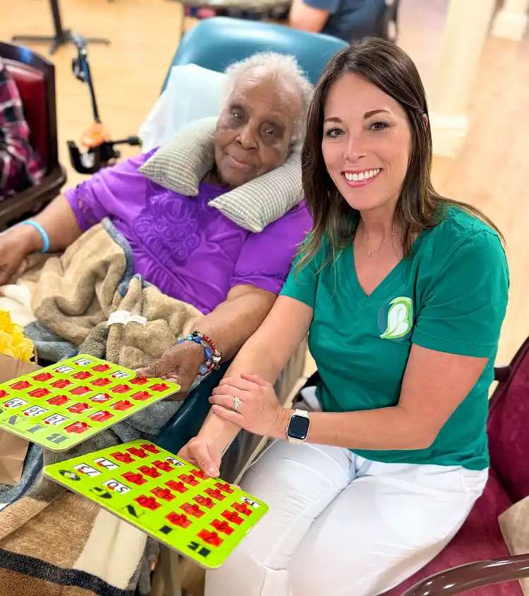 A young and an aged woman playing bingo at a nursing home in Bossier City, LA