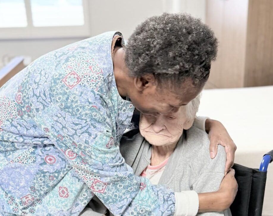 A woman in a wheelchair embraces an older woman, highlighting Palliative Care in Bossier City, LA