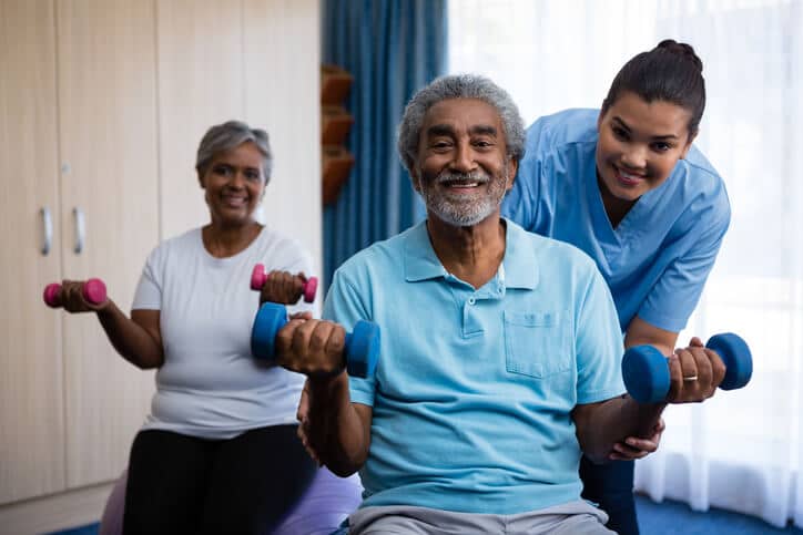 A senior man and woman with a therapist during occupational therapy