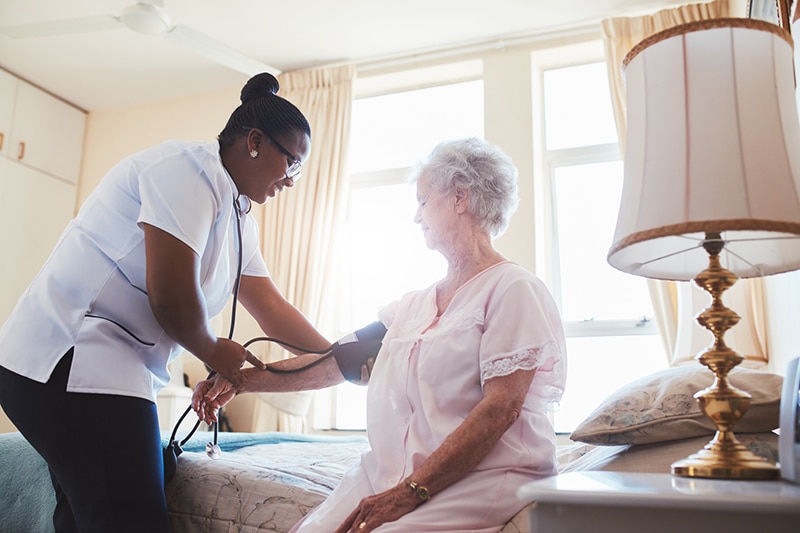 Nurse caring for a senior resident in a skilled nursing facility